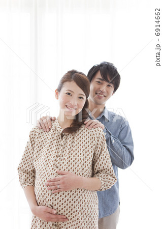 妊婦の肩に手を乗せる男性の写真素材