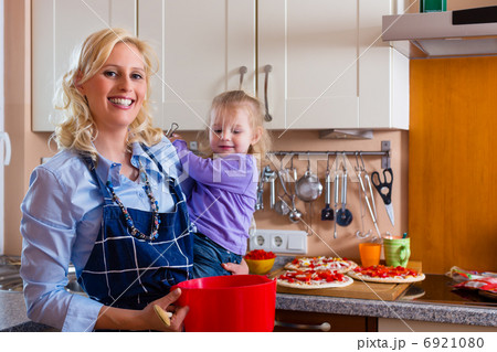 Family - mother and child baking pizza 6921080