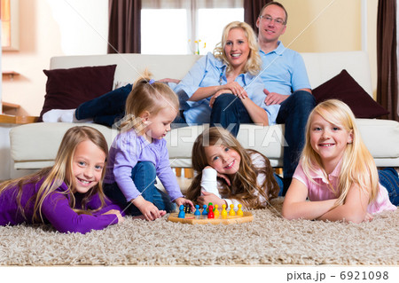 Family playing board game at home 6921098