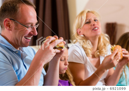 Family is eating hamburger or fast food 6921099