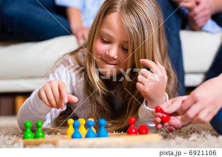 Family playing board game at home 6921106