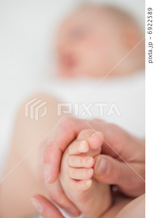 Feet of a baby being touched Feet of a baby being touched 6922589