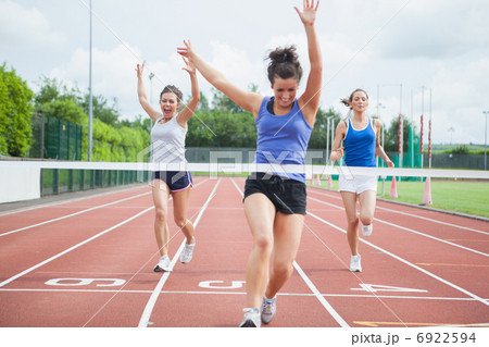 Athlete celebrates race win at finish line 6922594