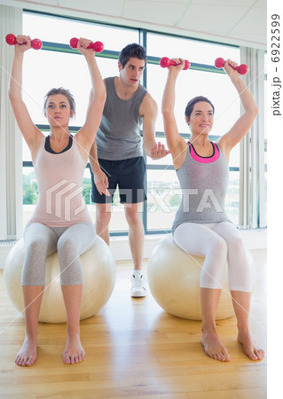 Trainer teaching class on exercise ball Trainer teaching class on exercise ball 6922599