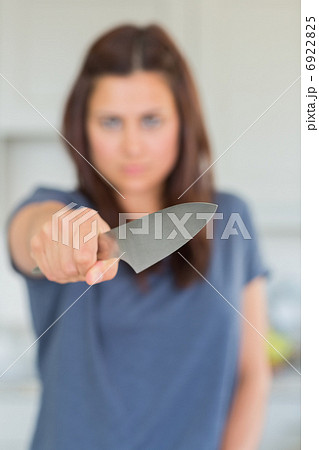 Woman holding knife out 6922825