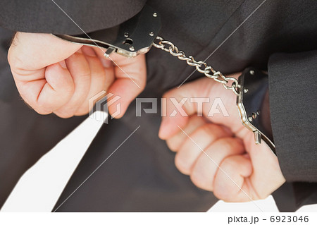 Businessman with handcuffs clencing fists Businessman with handcuffs clencing fists 6923046