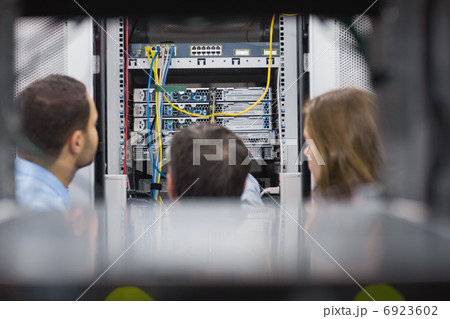 Technicians viewing a server Technicians viewing a server 6923602