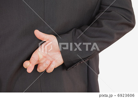 Businessman with fingers crossed 6923606