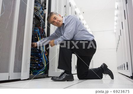 Man fixing server wires Man fixing server wires 6923675