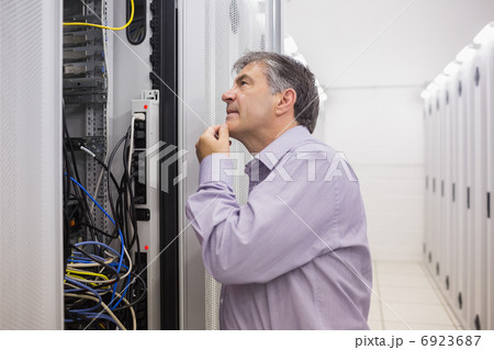 Man looking up thoughtfully into server locker Man looking up thoughtfully into server locker 6923687