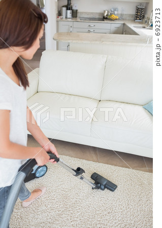 Woman cleaning the carpet Woman cleaning the carpet 6923713
