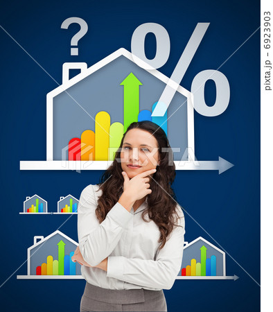 Thinking businesswoman standing against a energy efficient house 6923903