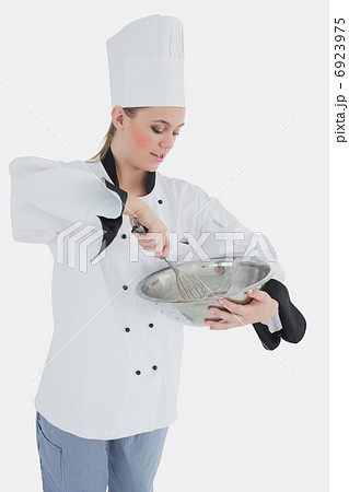 Chef holding wire whisk and mixing bowl Chef holding wire whisk and mixing bowl 6923975