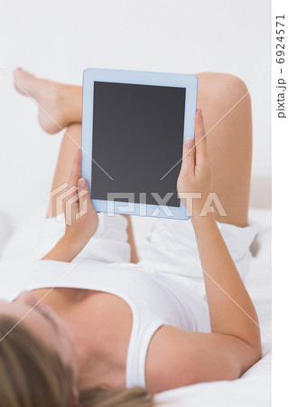Calm woman touching her tablet pc 6924571