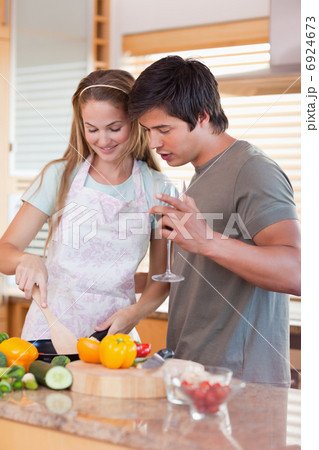 Happy couple cooking food together Happy couple cooking food together 6924673