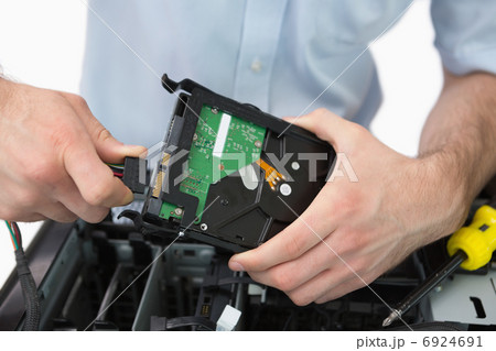 Hands fixing cable to hard disk Hands fixing cable to hard disk 6924691
