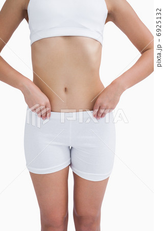 Midsection of fit woman in sportswear Midsection of fit woman in sportswear 6925132