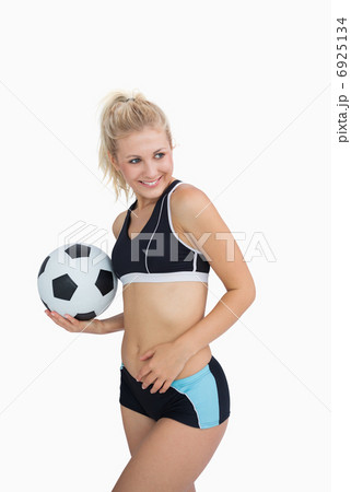 Portrait of happy woman in sportswear with football 6925134