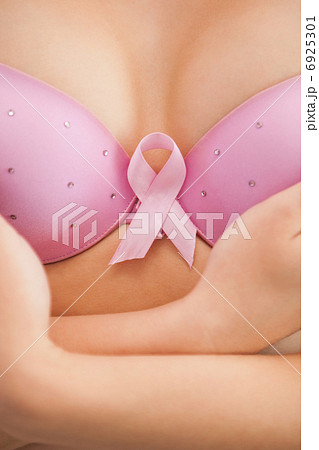 Woman in bra with breast cancer awareness ribbon 6925301