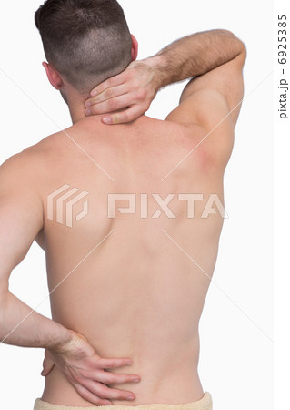 Rear view of shirtless man with neck pain over Rear view of shirtless man with neck pain over 6925385
