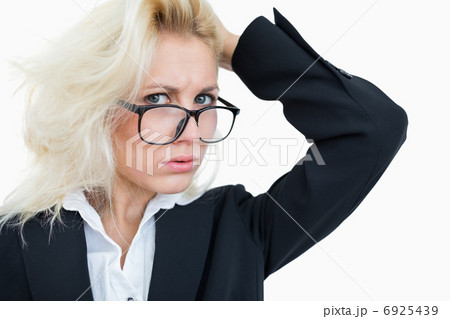 Close-up portrait of frustrated business woman scratching head 6925439