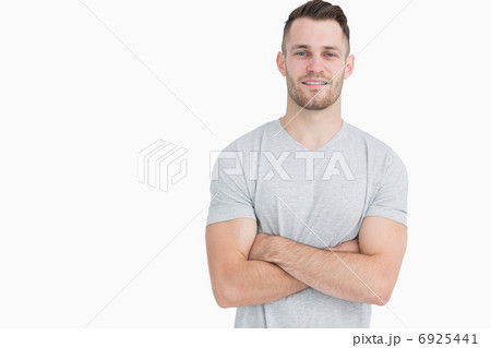 Portrait of casual young man standing with arms crossed Portrait of casual young man standing with arms crossed 6925441