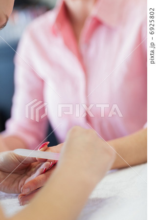 Woman filing fingernail 6925802