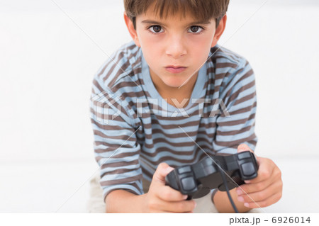Boy playing his game console 6926014