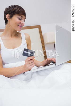 Smiling brunette shopping online Smiling brunette shopping online 6926326
