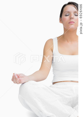 Young woman sitting in lotus position 6926486