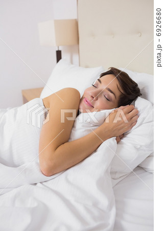 Woman sleeping comfortably in bed Woman sleeping comfortably in bed 6926680