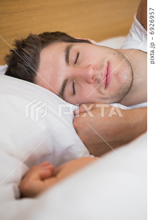 Man asleep in bed 6926957