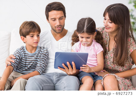 Happy family looking at tablet pc Happy family looking at tablet pc 6927273