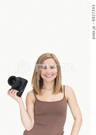 Portrait of happy female with photographic camera Portrait of happy female with photographic camera 6927393