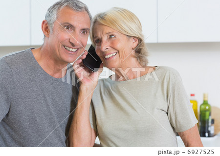 Couple taking a call together Couple taking a call together 6927525
