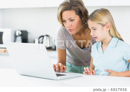 Mother and daughter using laptop Mother and daughter using laptop 6927938