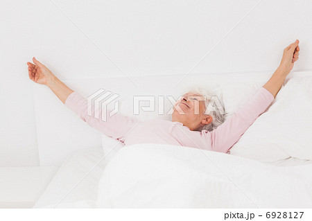 Woman stretching in bed 6928127