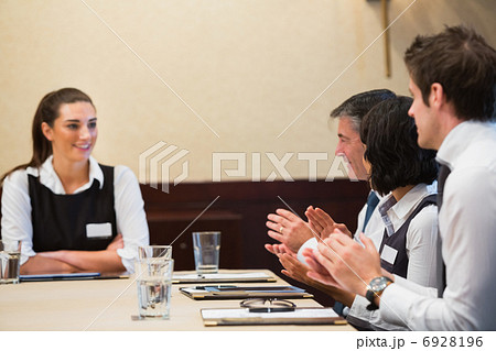 Business people clapping colleague 6928196
