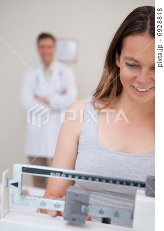 Weight measuring woman Weight measuring woman 6928848