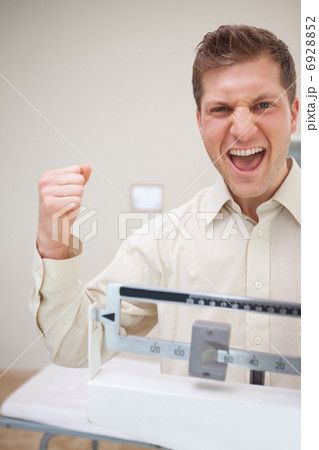 Man celebrating diet success Man celebrating diet success 6928852