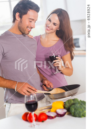 Lovers preparing food and drinking 6928924