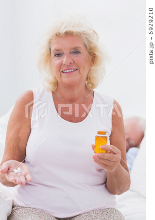Calm aged woman with the opened pill bottle Calm aged woman with the opened pill bottle 6929210
