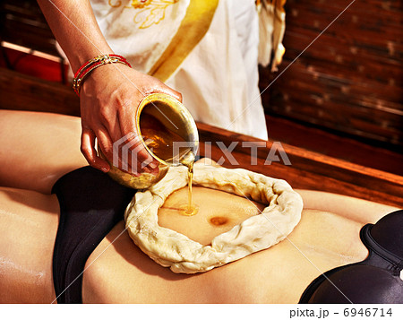 Woman having Ayurvedic spa treatment. 6946714