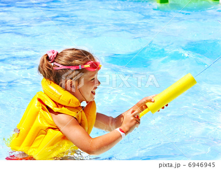 Child playing in swimming pool. Child playing in swimming pool. 6946945