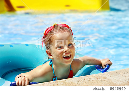 Kid sitting on inflatable ring. 6946949