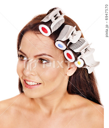 Woman wear hair curlers on head. 6947570