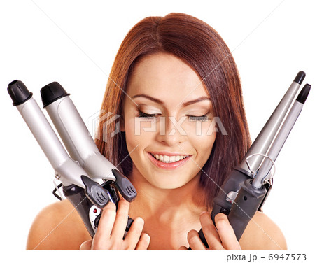 Woman holding iron curling hair. 6947573