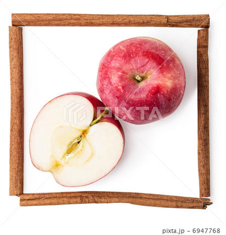 apples in a frame from sticks of cinnamon isolated on white 6947768