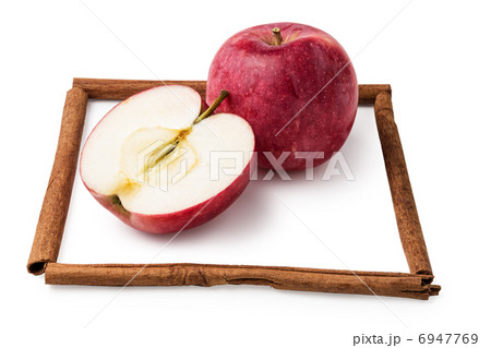 apples in a frame from sticks of cinnamon isolated on white 6947769