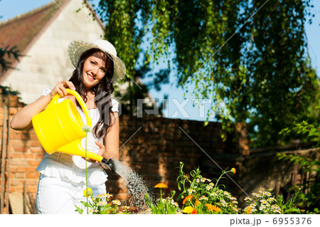 Gardening in summer - woman watering flowers Gardening in summer - woman watering flowers 6955376